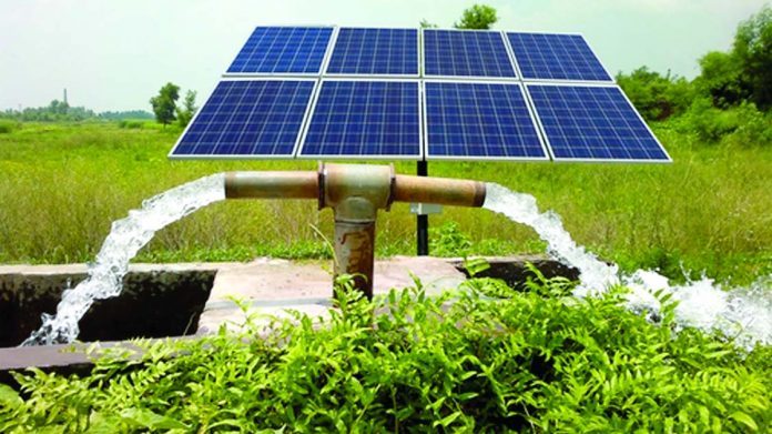 Solar-powered irrigation pump watering farmland