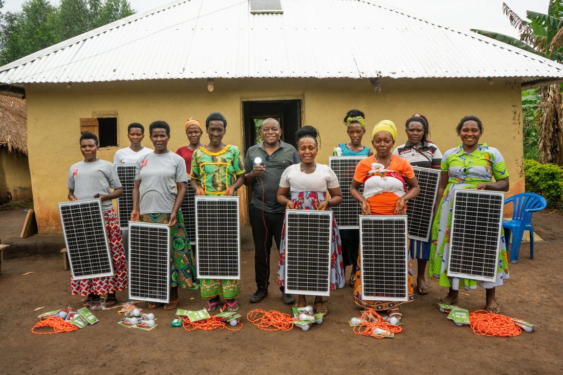 Community members receiving home solar panel kits