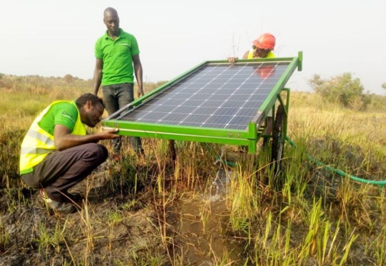 Team setting up a solar water pumping system
